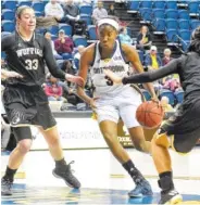  ?? STAFF PHOTO BY ROBIN RUDD ?? UTC’s Jasmine Joyner drives the lane between Wofford’s Grayson Pinholster and Sarah Traynor In the Mocs’ 76-56 win on Saturday. Joyner was announced as Southern Conference defensive player of the year on Tuesday.