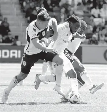  ?? Matthew Maxey Icon Sportswire via Getty Images ?? GALAXY FORWARD Joseph Paintsil splits Nashville SC’s Taylor Washington, left, and Brian Anunga during their match. Nashville took an early 2-0 lead before the Galaxy mounted a comeback to salvage a road draw.