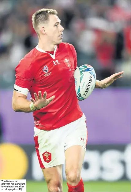  ??  ?? The Wales star delivers his signature try celebratio­n after scoring against Fiji