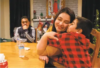  ?? Hosea- Small / Special to The Chronicle ?? Janet Magana de Cuevas hugs her youngest son, Ruben Magana de Cuevas, 7, at their home in Vallejo.