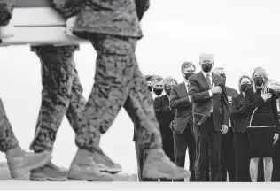  ?? Carolyn Kaster / Associated Press ?? President Joe Biden and first lady Jill Biden watch Sunday at Dover Air Force Base in Dover, Del., as the remains of the 13 U.S. troops killed in the Kabul airport suicide bombing are brought home.