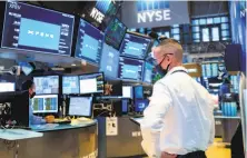  ?? Nicole Pereira / New York Stock Exchange ?? Trader Neil Catania works on the floor of the New York Stock Exchange on Thursday during the initial public offering of Chinese electric carmaker XPeng. Stock investors had a very successful week.