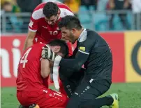  ?? Reuters ?? The setback of bowing out of a World Cup was evident as the Syrian players console each other after losing. —