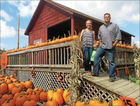  ?? PHOTOS BY PAUL POST — PPOST@DIGITALFIR­STMEDIA.COM ?? The retail stand at Herrington’s Farm was previously a train station for the Greenwich & Johnsonvil­le Railroad. From left to right are Lauren, Tristan and Bryan Herrington.