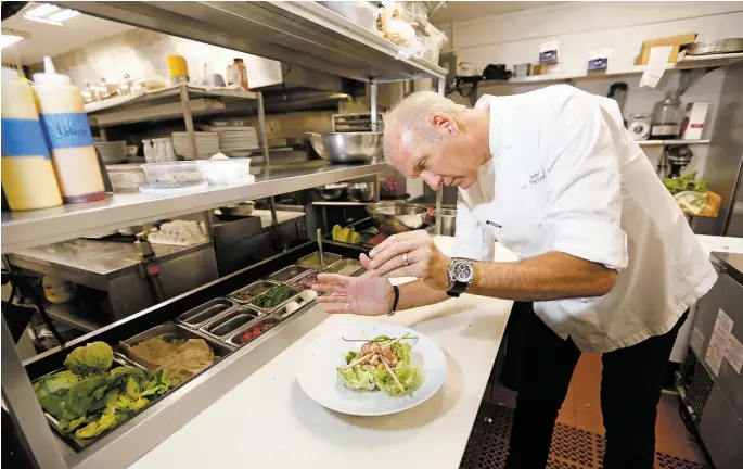  ?? photo Luis Sánchez Saturno/ The New Mexican ?? Chef Mark Kiffin readies a dish at The Compound,