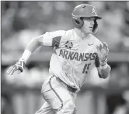 ?? NWA Democrat-Gazette/BEN GOFF ?? Arkansas third baseman Casey Martin runs to first after hitting a double in the fifth inning in a 5-2 victory over Florida on Friday in the College World Series at TD Ameritrade Park in Omaha. Martin went 4 for 5 with 3 runs scored and an RBI as his...