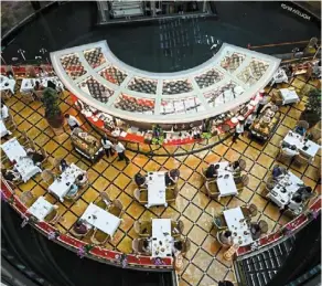  ?? — AFP ?? Before the ban: People eating out at a restaurant before the ban on dine-in comes into force in Singapore.