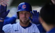  ?? Erin Hooley/Associated Press ?? The Cubs’ Michael Busch celebrates in the dugout after hitting a home run during the third inning of the game against the Dodgers on Friday in Chicago.