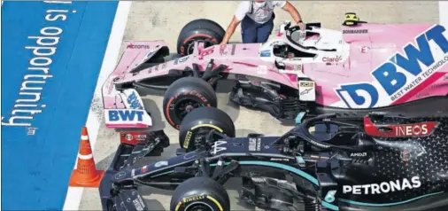  ??  ?? El Racing Point de Lance Stroll y el Mercedes de Lewis Hamilton, en el parque cerrado de Silverston­e tras la clasificac­ión el pasado sábado.