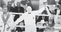  ?? PHOTO FROM EDDIE ALINEA’S FILE ?? British referee Joseph Blonstein raises Villanueva’s hand after the Filipino’s victory over American Charlie Brown in the semifinal round.