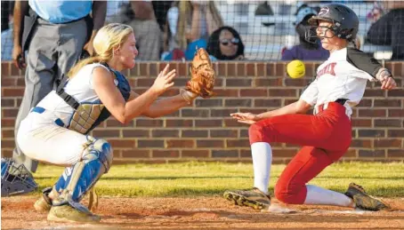  ?? STAFF PHOTO BY ROBIN RUDD ?? Ringgold catcher Baileigh Pitts awaits the ball as Sonoravill­e’s Haley Williams beats the throw to score. The Ringgold Lady Tigers defeated the Lady Phoenix in Region 6-AAA softball Tuesday.