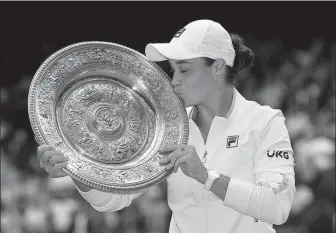  ?? REUTERS ?? Ashleigh Barty of Australia kisses the trophy after defeating Karolina Pliskova of the Czech Republic in Saturday’s women’s singles final at Wimbledon. Barty won 6-3, 6-7 (7), 6-3.
