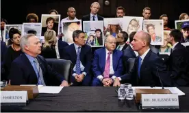  ?? Photograph: Michael Reynolds/EPA ?? Dennis Muilenburg, right, and vice-president and chief engineer John Hamilton sit in front of people holding pictures of loved ones during a US congressio­nal hearing.