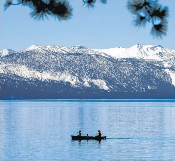  ??  ?? CANOEISTS ply the waters of Lake Tahoe, of which Mark Twain, in “Roughing It,” wrote: “I thought it must surely be the fairest picture the whole earth affords.”