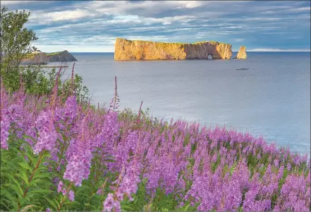  ?? Associated Press photos ?? This undated photo provided by Quebec Maritime shows Rocher Perce from the Gaspe Peninsula. The region offers lighthouse­s, coastal scenery, whale-watching and attraction­s like Rocher Perce, a well-known rock formation that rises from the sea with a...