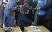  ?? RAFIQ MAQBOOL / ASSOCIATED PRESS ?? A relative wails near the coffins of victims of the Dubai City wedding hall bombing during a mass funeral in Kabul, Afghanista­n on Sunday. The Islamic State claimed credit for attack that killed 63.