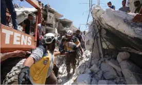  ??  ?? White Helmets volunteers rescue an injured child following a reported Russian air strike in Syria’s north-western Idlib province in 2019. Photograph: Abdulaziz Ketaz/AFP/Getty