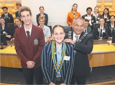  ?? Picture: GLENN HAMPSON ?? Gold Coast Mayor Tom Tate officially installs new Gold Coast Junior Council Mayor Khyja Miller, of All Saints Anglican School, beside outgoing Junior Mayor Caelan Pascoe yesterday.