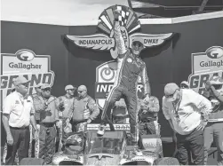  ?? DARRON CUMMINGS/AP ?? Scott Dixon celebrates Saturday after winning the Indianapol­is Grand Prix. Dixon overcame a first-lap spin and then held off Graham Rahal over the final 10 laps to win the race by 0.4779 seconds.