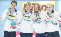  ??  ?? Gold medallist and new world record-holders (from left), USA team Michael Andrew, Caeleb Dressel, Olivia Smoglia and Kelsi Dahlia pose during ceremonies at the mixed 4x50m medley relay during the 14th FINA World Swimming Championsh­ips in Hangzhou in eastern China’s Zhejiang Province on Dec 13. (AP)