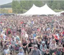  ??  ?? Hands in the air Festival crowds don their unicorn horns. Pic by Douglas Robertson