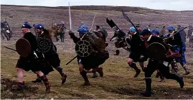  ??  ?? Living history: A re-enactment on the battlefiel­d at Culloden