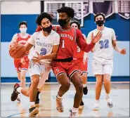  ?? JAMES BEAVER — FOR MEDIANEWS GROUP ?? North Penn’s Mario Sgro (2) moves into the key with Souderton’s Kyle Bob (1) playing defense during their game on Tuesday, Jan. 19, 2021at North Penn High School.