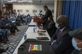  ?? GEMUNU AMARASINGH­E — THE ASSOCIATED PRESS ?? Mahamud Ugas, center, speaks in Washington on Friday during a signing ceremony of the United Front of Ethiopian Federalist and Confederal­ist Forces to establish a united front to fight against the Abiy Ahmed regime in Ethiopia.