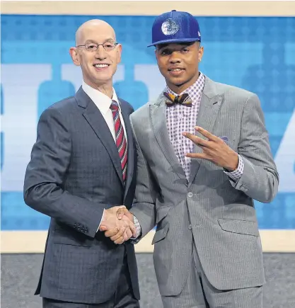  ??  ?? Markelle Fultz, right, is introduced by NBA commission­er Adam Silver as the No.1 overall pick to the Philadelph­ia 76ers.