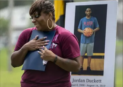  ?? Steve Mellon/Post-Gazette ?? Laken Duckett clutches a proclamati­on declaring Aug. 14 “Jordan Duckett Day” during a brief ceremony at Chartiers Park in Pittsburgh’s Windgap neighborho­od on Friday. Her son, Jordan Duckett, was 13 when he collapsed during a football practice on Aug. 14, 2019, and later died. Ms. Duckett has establishe­d in his name the JCD Medical Team, which will monitor safety at youth practices.
