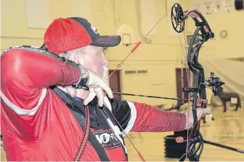  ?? ADAM MACINNIS/THE NEWS ?? Bruce Spears of Westville takes aim during a 3-D archery competitio­n hosted by the Northumber­land Strait Shooters on Feb. 16 at the West Pictou Consolidat­ed School.