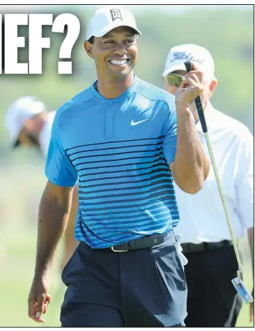  ?? — GETTY IMAGES ?? Tiger Woods breaks into a smile as he walks across a green during a practice round yesterday for the U.S. Open at Shinnecock Hills. It has been 10 years since Woods won his last U.S. Open, which was his 14th and last major.