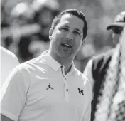  ?? Associated Press file Tony Ding, ?? Adam Schefter served as an honorary captain for the pregame coin toss before an NCAA college football game between Michigan and Cincinnati in Ann Arbor, Mich., in September 2017.