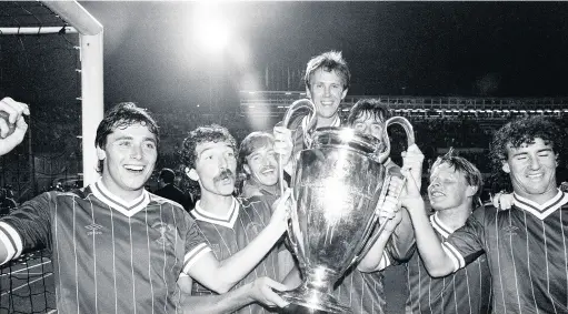  ??  ?? 1984 European Cup Final at the Stadio Olimpico, Rome. Liverpool 1-1 AS Roma. Liverpool won 4-2 on penalties. Liverpool players left to right: Michael Robinson, Graeme Souness, David Hodgson, Phil, Neal, Mark Lawrenson, Sammy Lee and Craig Johnston celebrate with the trophy on a lap of honour after the match, May 30 1984. (Photo by Monte Fresco/ Mirrorpix/Getty Images)