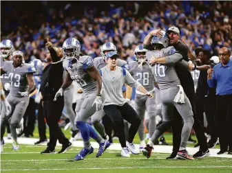  ?? Rey Del Rio / Getty Images ?? Detroit quarterbac­k Jared Goff (16) celebrates with head coach Dan Campbell after his touchdown pass beat the Vikings, ending a 15-game winless steak for the Lions.