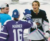  ?? MARTA LAVANDIER/AP ?? Canadiens’ Nick Suzuki, left, and Maple Leafs’ Mitchell Marner (16) congratula­te Canadian hockey player Sarah Nurse after she scored a goal during the NHL All Star Skills Showcase on Friday in Sunrise, Fla.