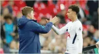  ?? — Reuters ?? Tottenham’s Dele Alli shakes hands with manager Mauricio Pochettino as he is substitute­d.