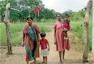  ??  ?? With live-wire fences on either side a family makes a dangerous trek along the road. The red cloth indicates the fence is live