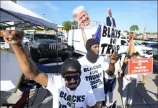  ?? Wilfredo Lee/Associated Press ?? Supporters of former President Donald Trump cheer Thursday as he arrives at federal court in Fort Pierce, Fla.