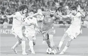  ?? — Gambar AFP ?? DIASAK: Penyerang Lubnan Omar Bugiel (tengah) diasak pemain Tajikistan pada perlawanan Piala Asia Kumpulan A di antara Tajikistan dan Lubnan di Stadium Jassim bin Hamad di Doha, kelmarin.
