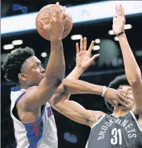  ?? AP ?? IN YOUR FACE! Stanley Johnson goes to the basket for two of his 17 points as Jarrett Allen defends.