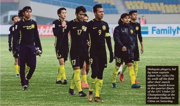  ??  ?? Malaysia players, led by team captain Adam Nor Azlin (No 9), walk off the field after their match against South Korea in the quarter-finals of the AFC Under-23 Championsh­ip at the Kunshan Stadium in China on Saturday.