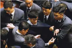  ??  ?? Security guards block Leung from retaking his oath inside the chamber.