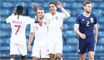  ??  ?? Portugal’s Helder Costa (second right) celebrates scoring their first goal with Bruma and Kevin Rodrigues during an internatio­nal friendly match against Scotland at Hampden Park in Glasgow, Britain. — Reuters photo
