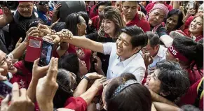  ??  ?? One more time: Marcos Jr surrounded by supporters after attending the recount of votes at the Supreme Court sitting in Manila. — AFP