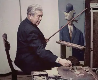  ??  ?? René Magritte, painting ‘Man in a Bowler Hat’ in his Brussels dining room, 1964