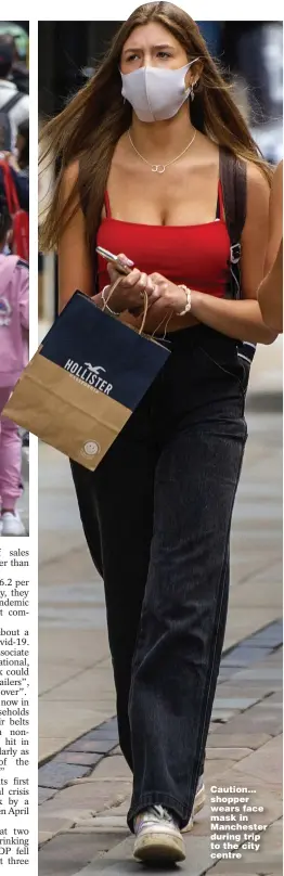  ??  ?? Caution... shopper wears face mask in Manchester during trip to the city centre