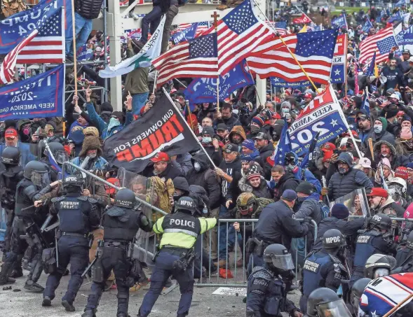  ?? GETTY IMAGES ?? Trump supporters clash with police and security forces as they storm the U.S. Capitol in Washington, D.C., on Wednesday. The mob breached security and entered the Capitol as Congress began the process to certify the 2020 presidenti­al election.