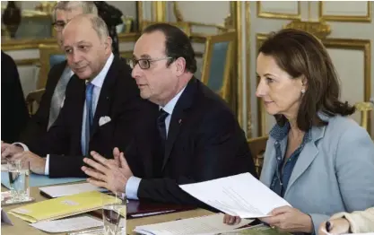 ??  ?? PARIS: French President Francois Hollande, center, his Foreign Affairs Minister Laurent Fabius, left, and Ecology Minister Segolene Royal meet with representa­tives of NGOs specialize­d in environmen­tal issue at the Elysee Palace in Paris, yesterday....