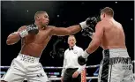  ?? PHOTO: AP ?? Italian referee Giuseppe Quartarone was a recurring feature in the fight, often intervenin­g when the pair came into close quarters.